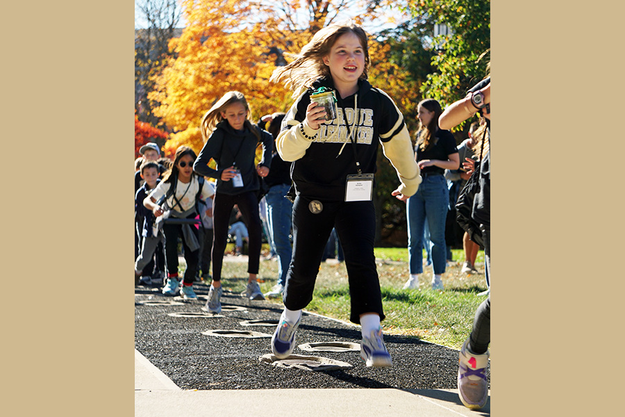 a child hops in Neil Armstrong's footsteps