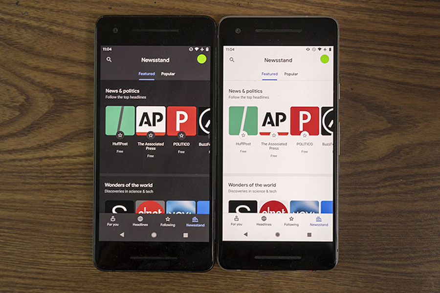 two cell phones showing dark mode and light mode