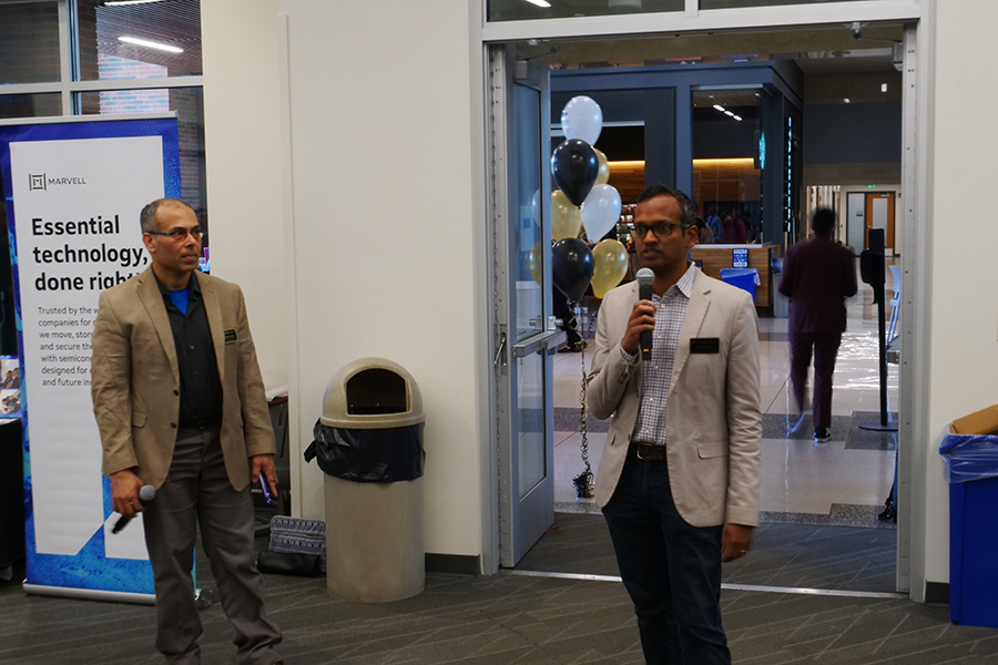 Saurabh Bagchi and Milind Kulkarni stand before the attendees of the career fair.