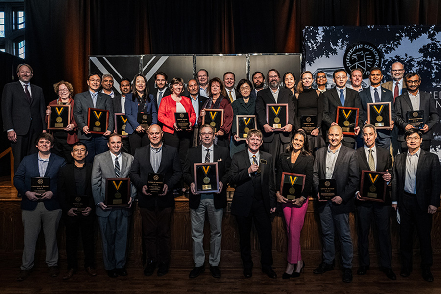 Program honorees gathered on stage with their ribbons and plaques.