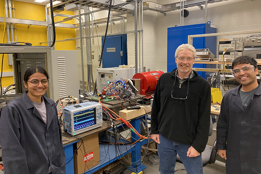 Standing in front of the dual rotor homopolar alternating current machine are (from left) Harshita Singh, Visiting Assistant Professor; Scott Sudhoff, Michael and Katherine Birck Professor of Electrical and Computer Engineering; and Avyay Sah, Graduate Student