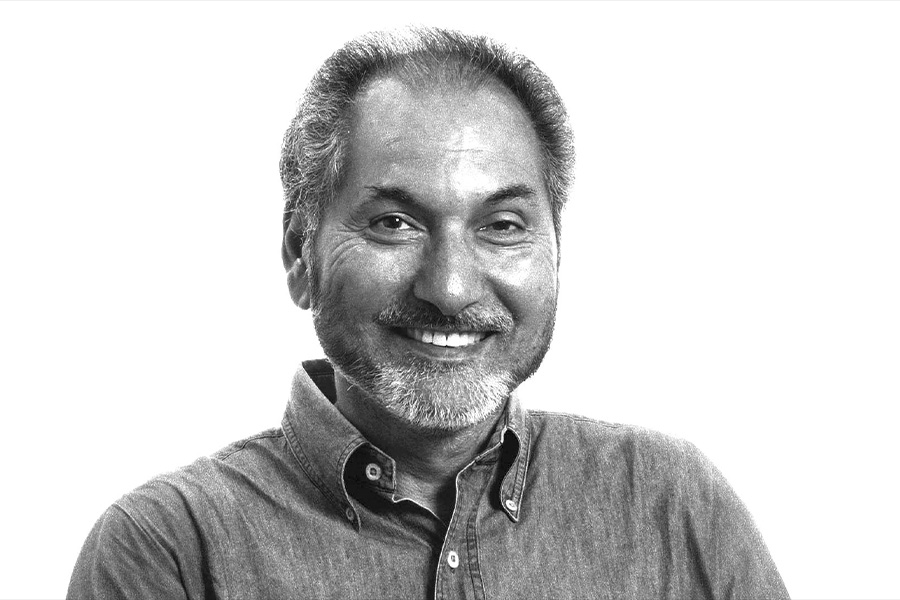 a black and white photo of a smiling man with a beard