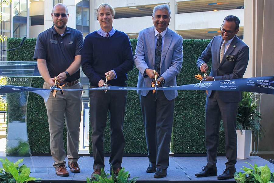 Four men participate in a ribbon-cutting ceremony, symbolizing the opening of the new space in BHEE