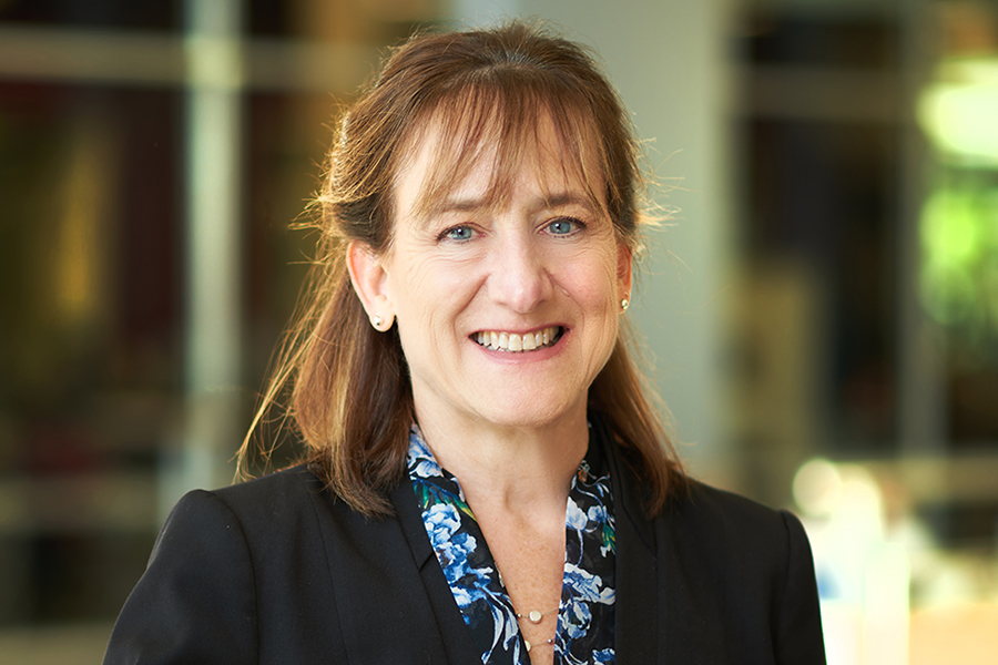 Carla Zoltowski poses for a portrait in the atrium of the MSEE building. She is wearing a dark blouse and a dark jacket. She has light brown hair cut with bangs.