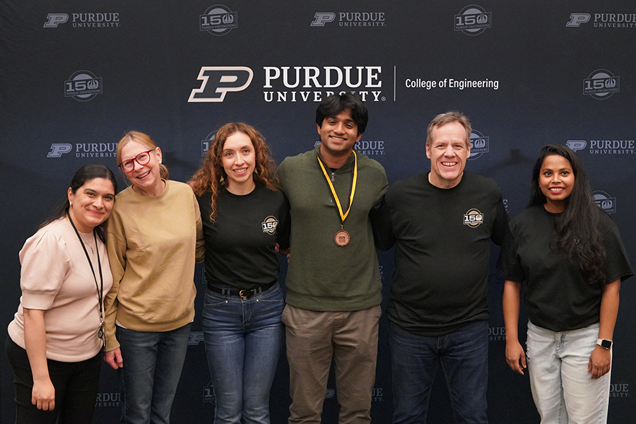 People standing in front of backdrop that says Purdue College of Engineering