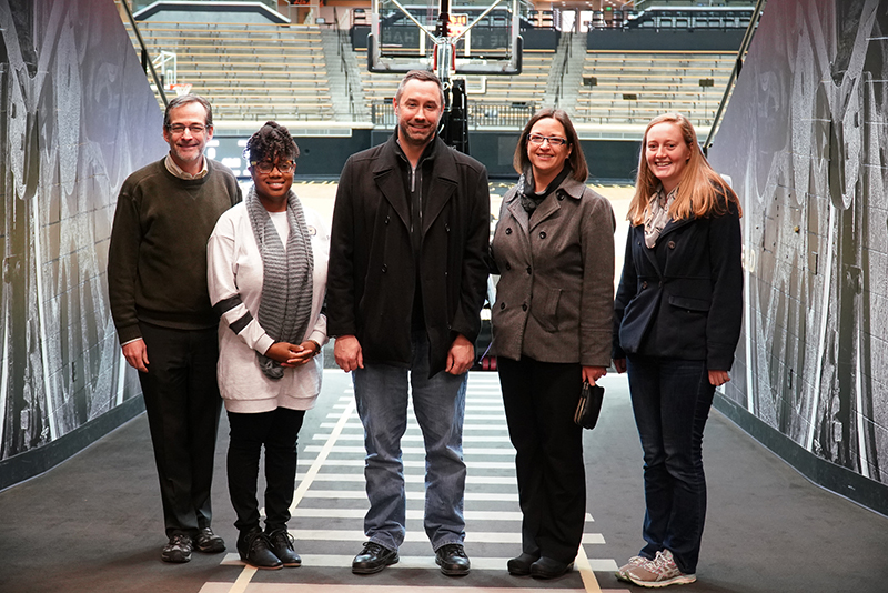 Amanda standing in Mackey Arena with Purdue professors