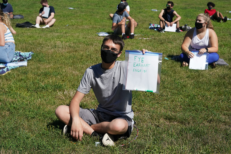 Student holding up sign with "FYE Earhart ENGR 131"