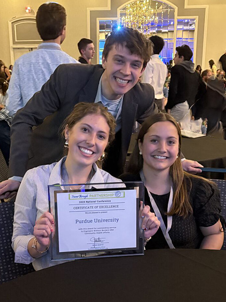 Three students smiling