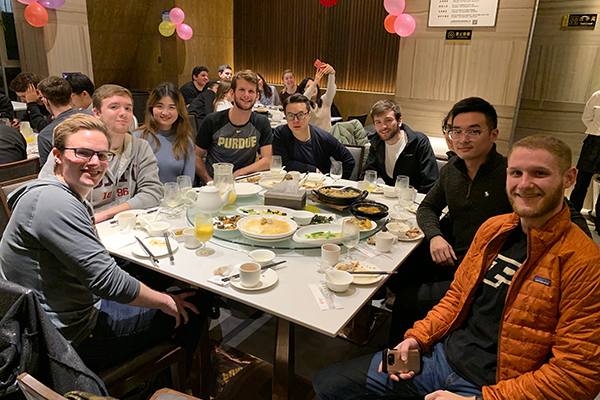 Students around a table eating