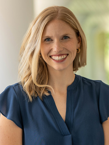 Woman with blonde hair, blue eyes, smiling